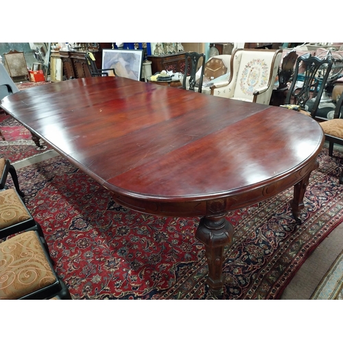 349 - 19th C. mahogany extendable dining table raised on fluted legs and brass castors with five leaves {8... 