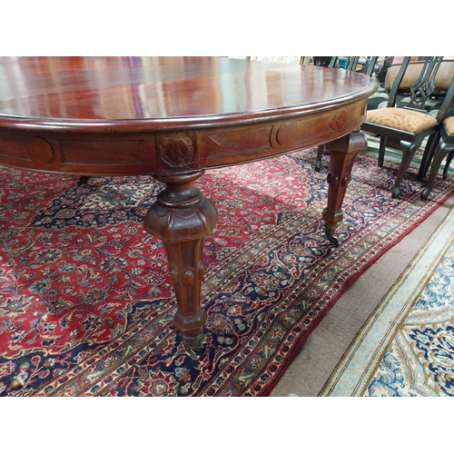 349 - 19th C. mahogany extendable dining table raised on fluted legs and brass castors with five leaves {8... 