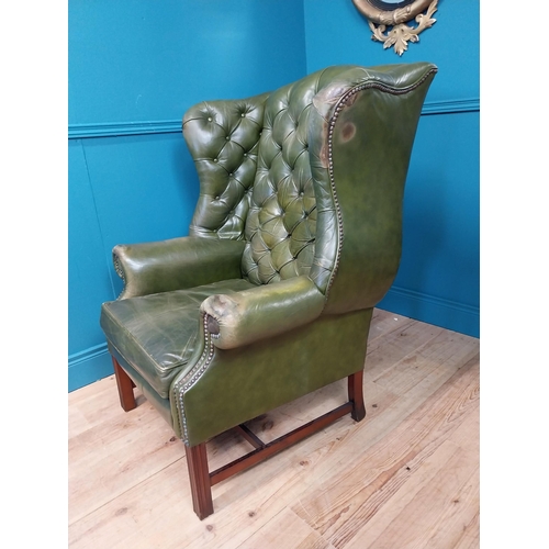 379 - Hand dyed deep buttoned leather wingback arm chair raised on square legs and single stretcher {111 c... 