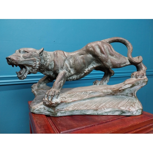 380 - Bronzed terracotta model of lion on craggy rock. {25 cm H x 41 cm W x 18 cm D}.