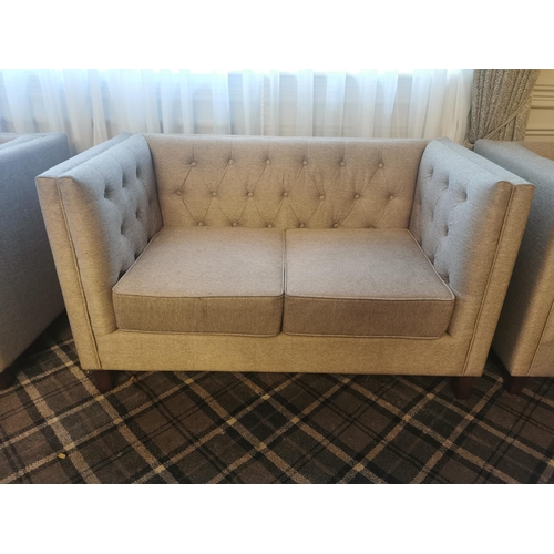 51 - Deep buttoned upholstered and mahogany two seater sofa {61 cm H x 140 cm W x 73 cm D}.