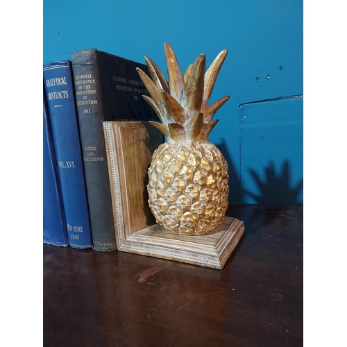 702 - Pair of hand painted wooden bookends in the form of pineapples {17 cm H x 13 cm W x 16 cm D}.