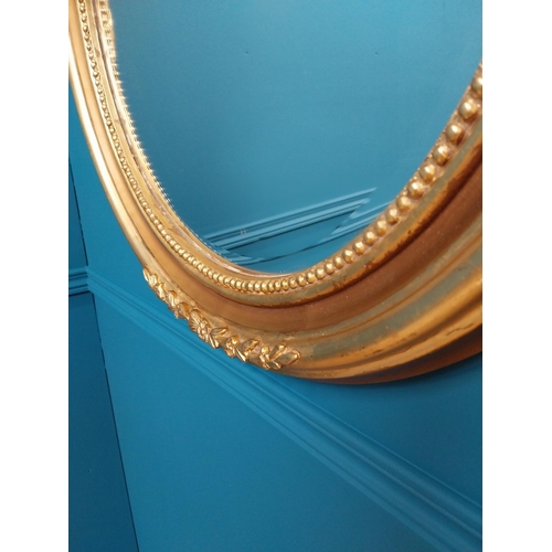 73 - Good quality gilt circular wall mirror with bevelled glass {70 cm H x 60 cm W}.