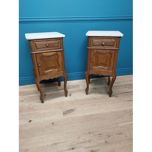 270 - Pair of early 20th C. oak bedside cabinets with marble tops and single drawer above panelled door ra... 