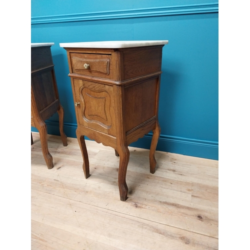 270 - Pair of early 20th C. oak bedside cabinets with marble tops and single drawer above panelled door ra... 