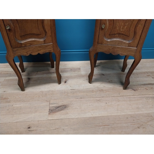 270 - Pair of early 20th C. oak bedside cabinets with marble tops and single drawer above panelled door ra... 