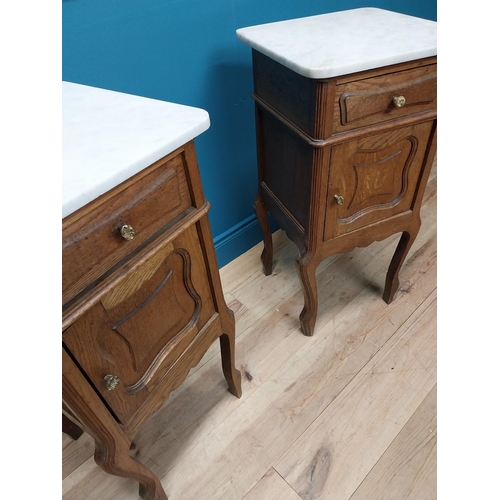 270 - Pair of early 20th C. oak bedside cabinets with marble tops and single drawer above panelled door ra... 