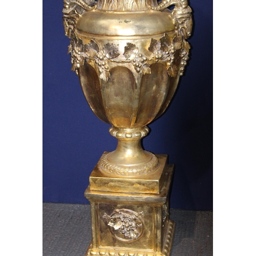 270A - Large gold lidded urn decorated with rams heads on base {H 206cm x D 70cm}.