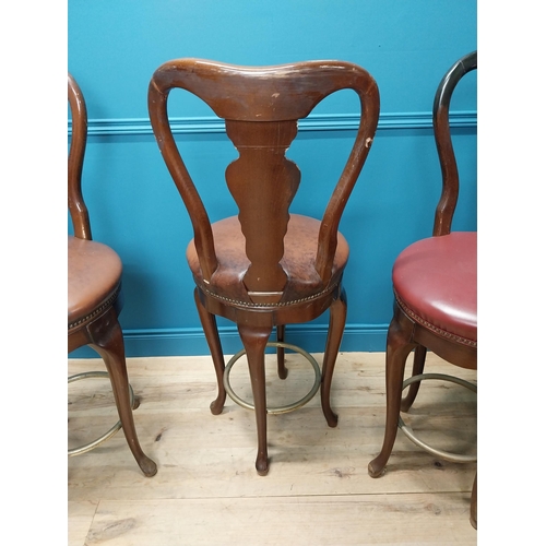 272 - Set of three mahogany high back swivel bar stools with leather upholstered seats raised on cabriole ... 