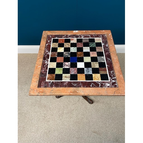 159 - Decorative marble topped games table with inset chess board squares raised on turned column and thre... 