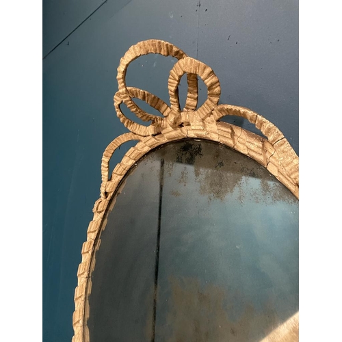 300A - Georgian painted oval mirror with original glass surmounted with bows.  { 73 cm H X 52 cm W }.