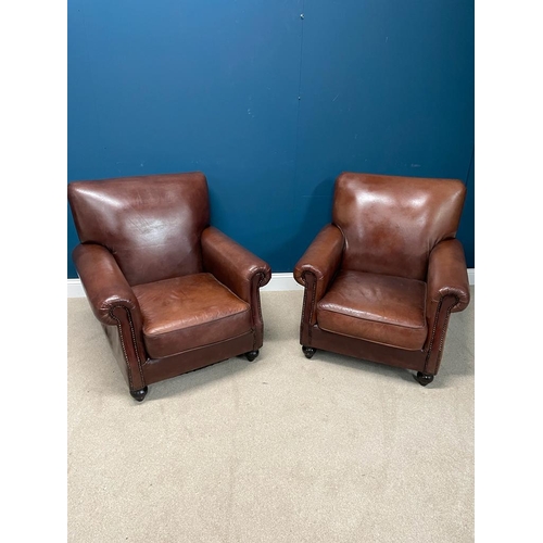 383 - Pair of leather upholstered club chairs raised on bun feet. {  90 cm H X 90 cm W  X 95 cm D }.