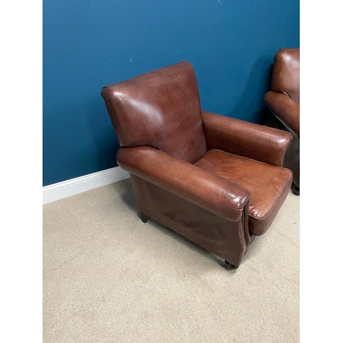 383 - Pair of leather upholstered club chairs raised on bun feet. {  90 cm H X 90 cm W  X 95 cm D }.