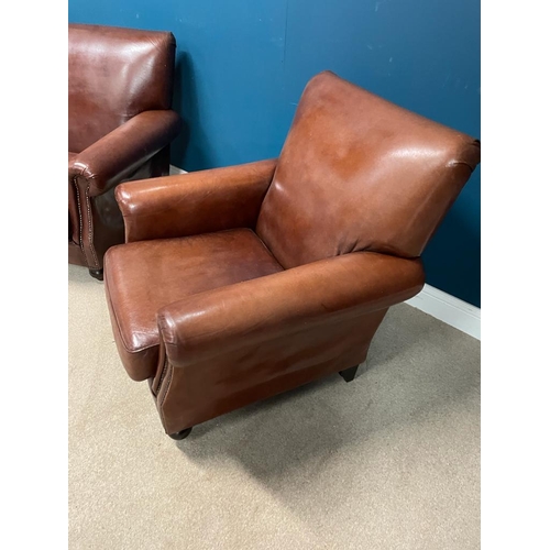 383 - Pair of leather upholstered club chairs raised on bun feet. {  90 cm H X 90 cm W  X 95 cm D }.