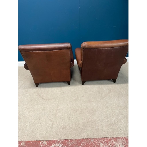 383 - Pair of leather upholstered club chairs raised on bun feet. {  90 cm H X 90 cm W  X 95 cm D }.