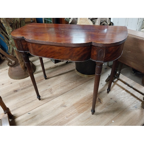 103 - Edwardian mahogany serpentine front side table raised on turned tapered reeded legs {74 cm H x 90 cm... 