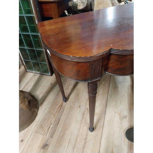 103 - Edwardian mahogany serpentine front side table raised on turned tapered reeded legs {74 cm H x 90 cm... 