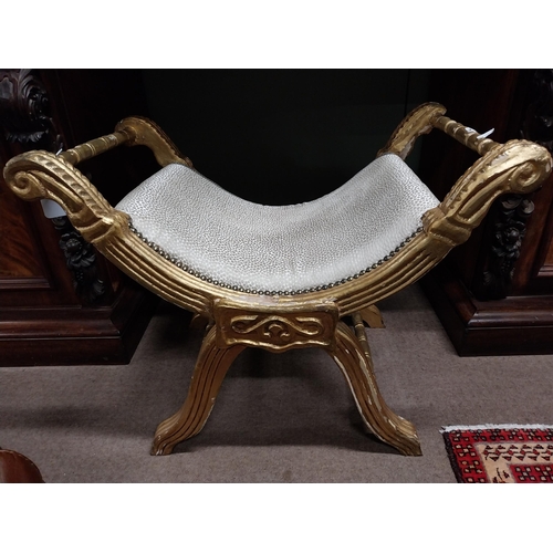 303A - Giltwood upholstered stool raised on x- framed supports.