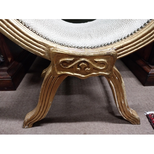 303A - Giltwood upholstered stool raised on x- framed supports.