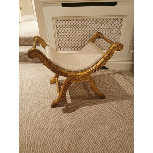 303A - Giltwood upholstered stool raised on x- framed supports.