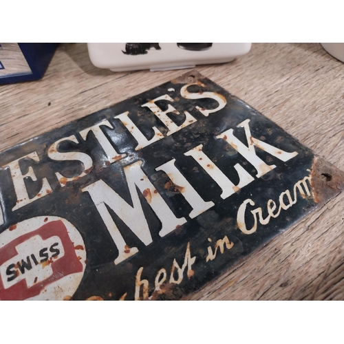 107 - Nestle's Milk enamel advertising sign. {14 cm H x 20 cm W}.