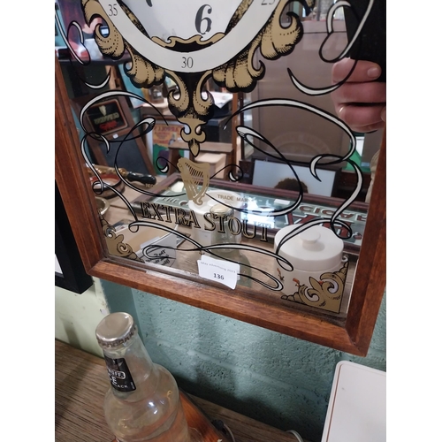 136 - Guinness advertising clock in mahogany frame with mirrored glass. {54 cm H x 29 cm W x 9 cm D}.