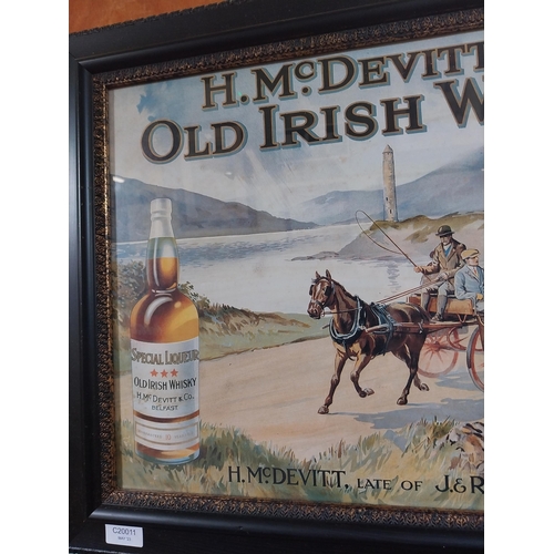 64 - H McDevitt Old Irish Whiskey advertising print in wooden frame. {50 cm H x 66 cm W}.