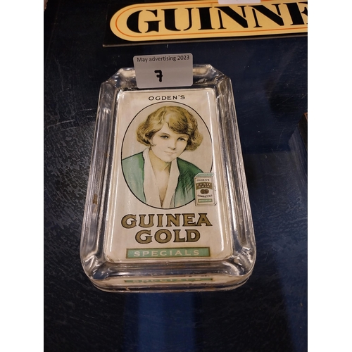 7 - Ogden's Guinea Gold glass ashtray. {15 cm H x 9 cm W}.