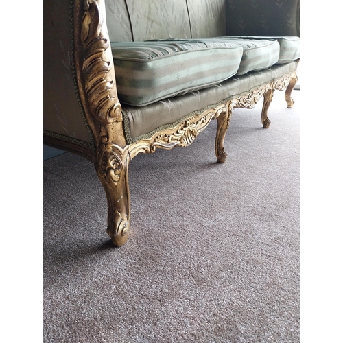 42 - Decorative hand carved giltwood and upholstered three seater sofa in the French style {116 cm H x 23... 