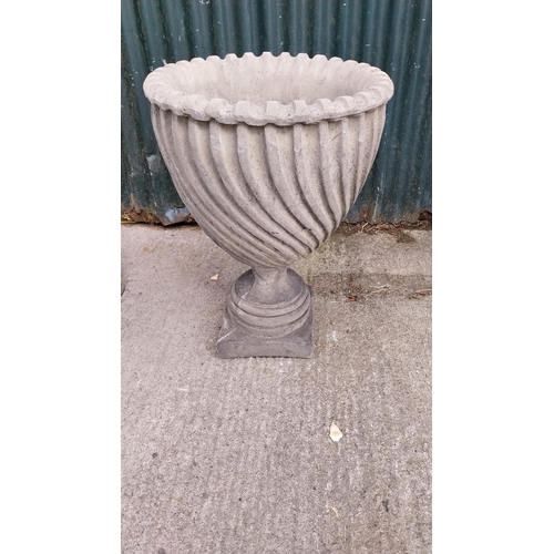 25 - Pair of moulded stone urns with spiral design {65 cm H x 46 cm Dia}.