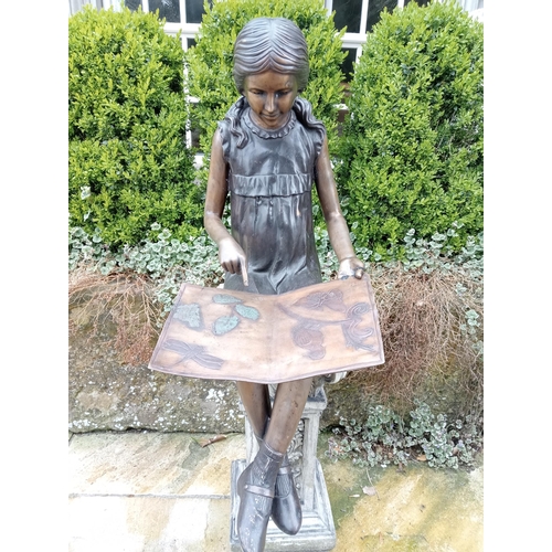 36 - Bronze figure of a Girl reading {H 60cm x W 37cm x D 50cm}