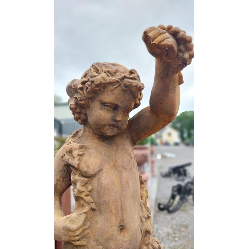 42 - Moulded sandstone statue of a Cherub decorated with grape vines {139 cm H x 40 cm W x 50 cm D}.