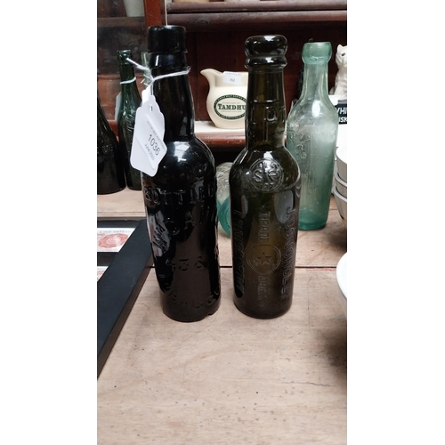 1036 - Two 19th C. bottles - William Cahill Baggot Street and J Donohoe Enniscorthy. {23 cm H}.