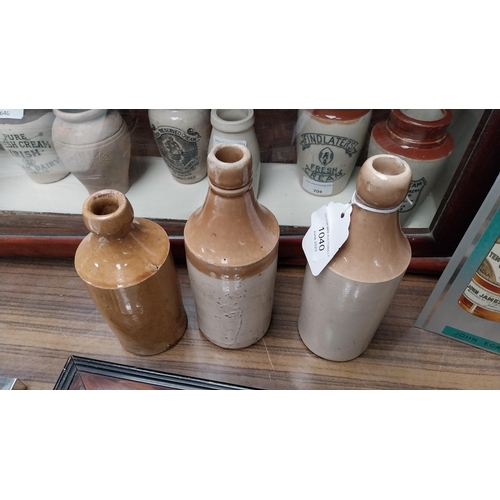 1040 - Three 19th C. stoneware ginger beer bottles{20 cm H}