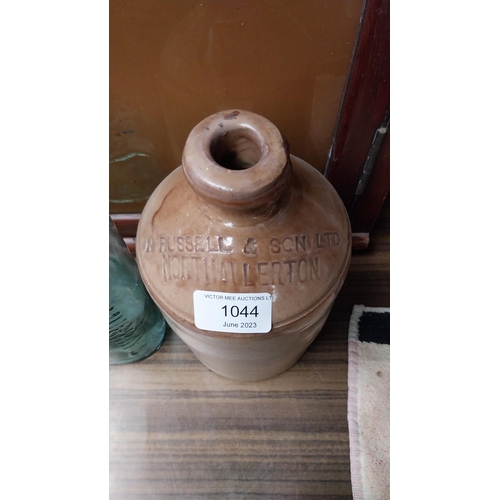 1044 - Stoneware flagon with missing handle - Russell and Sons Northallerton. {22 cm H}.