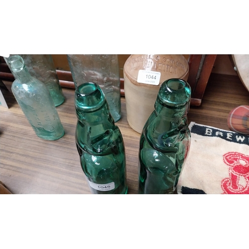 1045 - Two repro cod bottles {24 cm H}.