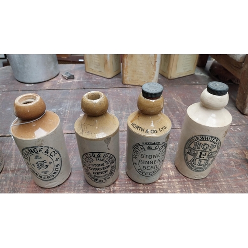 1051 - Four 19th C. stoneware ginger beer bottles - Whitehead and Denbigh, Strange and Co, North and Co Ltd... 