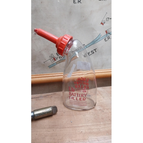 180 - Glass Lucas Battery filler advertising bottle. {18 cm H x 8 cm W}.