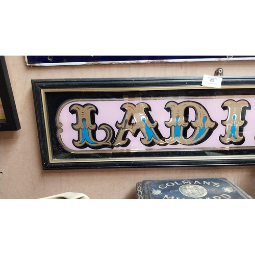 43 - Two framed glass Ladies and Gentlemen signs. {20 cm H x 75 cm W}.