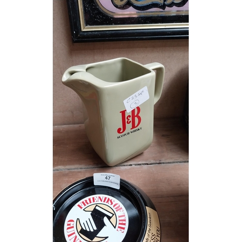 50 - J and B Scotch Whiskey ceramic water jug. {16 cm H x 16 cm W x 9 cm D}.