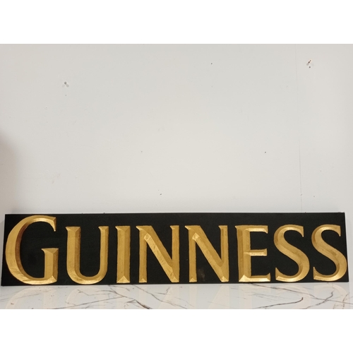 1261 - Guinness wooden advertising sign {H 20cm x W 100cm x D 3cm }.