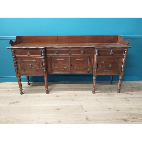 101 - 19th C. Irish mahogany side board with gallery back and three drawers in the frieze above four blind... 