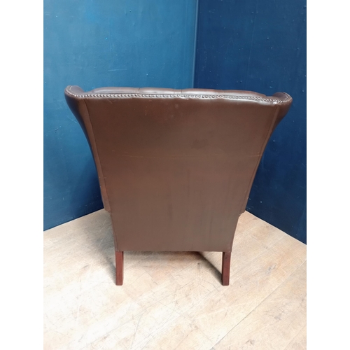 103 - Brown leather deep button wingback chair raised on square legs {H 95cm x W 85cm x D 65cm }.