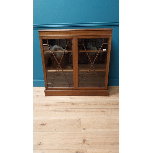 112 - Good quality Edwardian mahogany bookcase with two astral glazed doors raised on platform base {92 cm... 