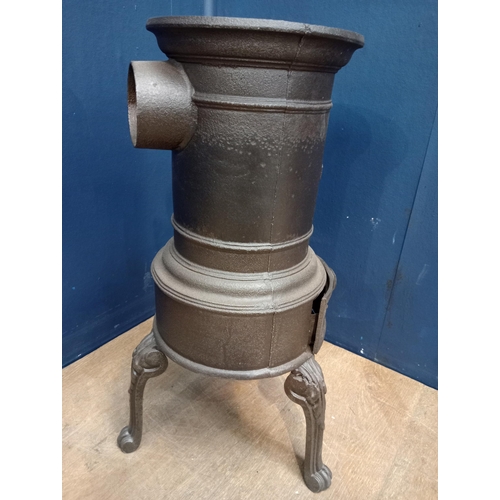 119 - Cast iron three legged stove {H 58cm x W 34cm x D 34cm}.