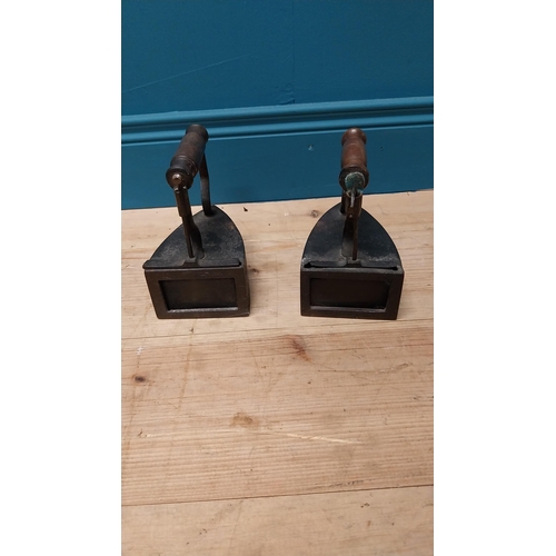 121 - Pair of early 20th C. irons with turned wooden handles {17 cm H x 17 cm W x 11 cm D}.