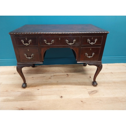 137 - Edwardian mahogany desk with inset leather top and brass handles raised on cabriole legs and ball an... 