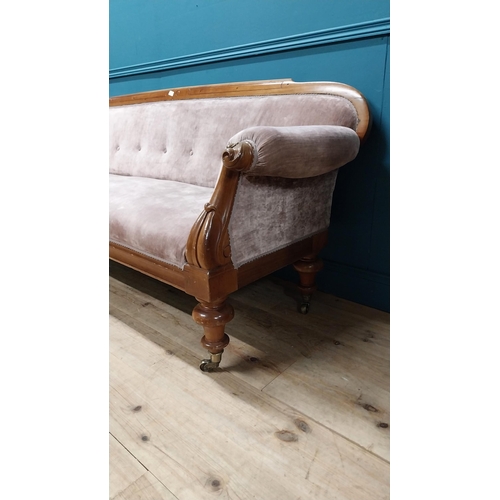 141 - Victorian mahogany and upholstered three seater sofa raised on turned legs and brass castors {87 cm ... 