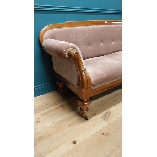 141 - Victorian mahogany and upholstered three seater sofa raised on turned legs and brass castors {87 cm ... 