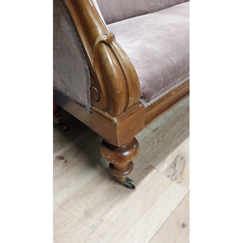 141 - Victorian mahogany and upholstered three seater sofa raised on turned legs and brass castors {87 cm ... 